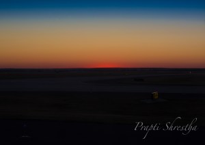 Sunset seen from the plane window at Denver International Airport during sunrise