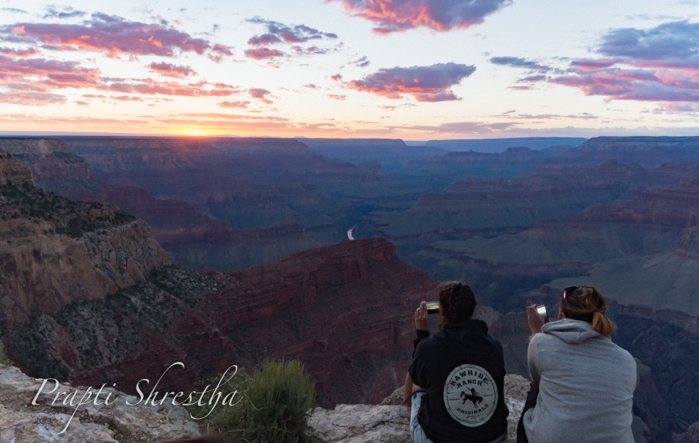Two girls capture the Grand Canyon Sunset in their mobile devices